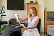 © JENOCHE - Woman in white dress sitting at the piano. Woman playing piano were digitally modified.