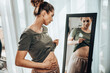 © milanmarkovic78 - Woman Touching Fat Belly While Standing Near Mirror