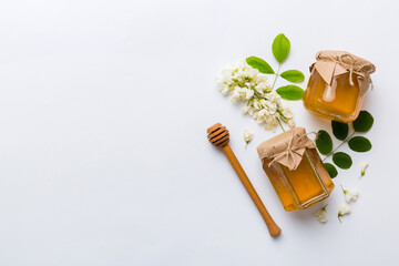 honey jar with acacia flowers and leaves. fresh honey top view flat lay