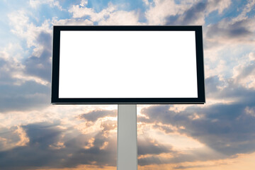 Wall Mural - mock up, front view - blank white billboard against warm sunset sky. sun beams shining through drama