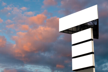 Wall Mural - mock up - four blank white billboards against warm sunset sky with clouds. consumerism, white screen