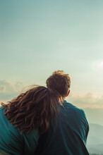Young Couple:a Man And A Woman Sit Together, Look Into The Distance At A Beautiful Blue Sky , Bow Their Heads On Their Shoulders Relationship,love, Outdoor Recreation,dreams,travel, Family