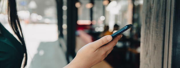 Wall Mural - man holding smart phone  in cafe