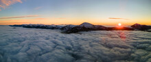 Aerial View Of Vibrant Sunrise Over White Dense Fog With Distant Dark Carpathian Mountains On Horizon
