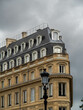 Close up of the clock in Place de la Comédie, with beautiful historic buildings in the background in the center of the city, Bordeaux, France.