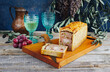 Traditional French Pate en croute with rabbit meat and pork filet served with grapes as close-up on a modern design wooden board