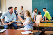 Positive Adult Students Communicating During Recess Between Lectures In Classroom