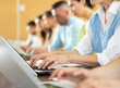 © JackF - Hands of woman university student using laptop during lesson.
