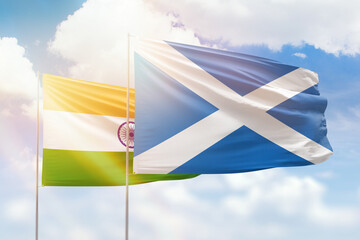 Sunny blue sky and flags of scotland and india