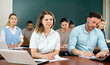 © JackF - Woman and man university students sitting at table during lesson.