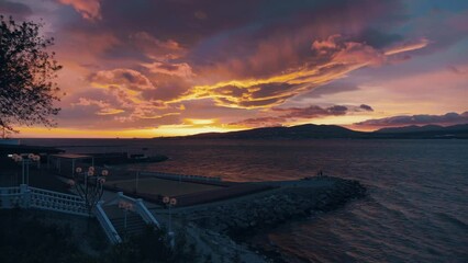 Wall Mural - Amazing dramatic colorful sunset with bright cloudy sky over sea bay in Gelendzhik embankment panorama. Travel destinations, summer resort for travel and rest.