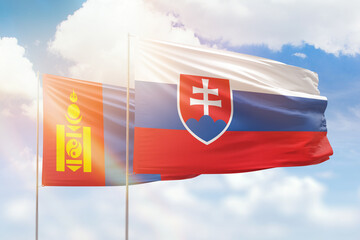 Sunny blue sky and flags of slovakia and mongolia