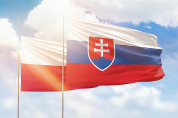 Wall Mural - Sunny blue sky and flags of slovakia and poland