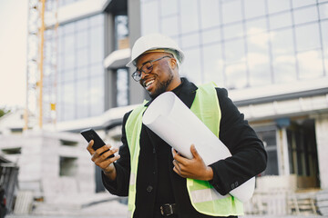 Black architect with project talk by phone