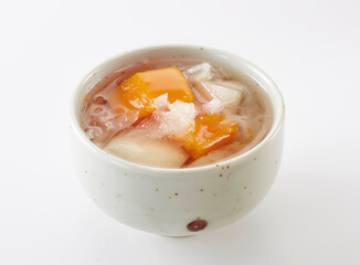 Delicious Chinese dessert, papaya Sydney and white fungus syrup.on white background