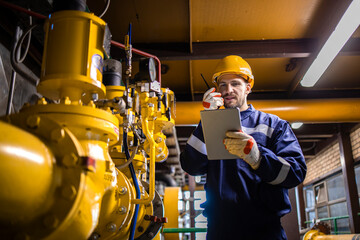 Wall Mural - Refinery worker supervisor checking natural gas consumption and pipeline installations in petrochemical industry.