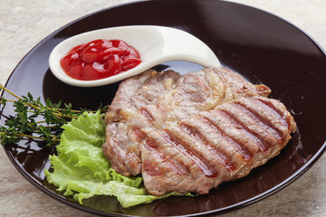 Grilled pork neck steak with ketchup