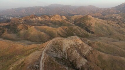 Canvas Print - High angle view of Santa Clarita Valley in Southern California, including Forest Service road and distant mountains of Angeles National Forest