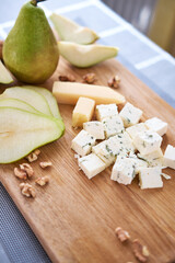 Wall Mural - Sliced Blue cheese, pears and walnuts on wooden board