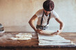 © Westend61 - Baker arranging dough on napkin in bakery