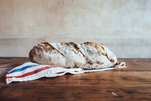 Freshly Baked Country Bread On Napkin In Bakery