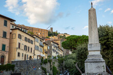 Italy, Province Of Arezzo, Cortona, Monument At Piazza Garibaldi With Town Houses In Background