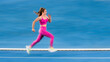 © Westend61 - Young sportswoman sprinting on running track