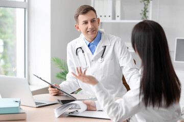 Wall Mural - Medical assistants working at table in clinic