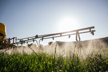 Crop Sprayer Spraying Fertilizer On Field On Sunny Day