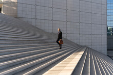 Businessman With Bag Moving Up On Steps