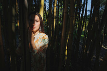 Woman Standing In Bamboo Grove