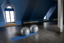 Gray Color Exercise Balls On Mat In Empty Fitness Room