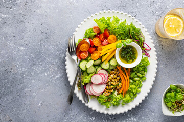 Wall Mural - Healthy chopped salad with fresh vegetables, sprouts and sauce. Concept clean eating. Top view.