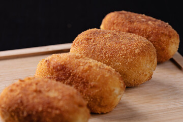 Wall Mural - Tapa of croquettes on black background 