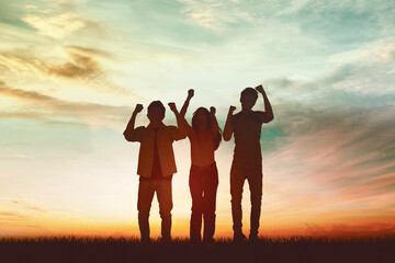 Silhouette of three people expressing happy at park