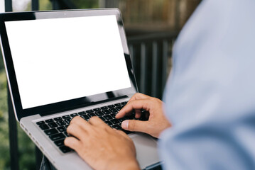 male hand working with laptop mock up blank screen computer desktop with keyboard.