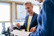 © Westend61 - Businessman and businesswoman working together on digital tablet and papers in office