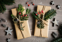 Studio Shot Of Naturally Wrapped Christmas Presents Decorated With Spruce Twigs