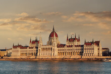 Orszaghaz Parliament Neo-Gothic Building And River Danube View At Sunset, With Clouds Above, UNESCO World Heritage Site, Budapest, Hungary