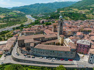 Aerial view of Bobbio, a town on the Trebbia river. Bridge. Piacenza, Emilia-Romagna. Details of the urban complex, roofs and bell towers of the town between the valleys of the Apennines. Italy
