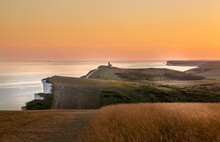 Beachy Head And The Belle Tout Lighthouse At Dusk, Near Eastbourne, East Sussex, England