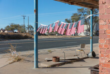 American Flags In Front Of Abandoned Gas Station.