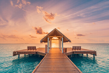 Canvas Print - Amazing sunset landscape. Picturesque summer sunset in Maldives. Luxury resort villas seascape with soft led lights under colorful sky. Dream sunset over tropical sea, fantastic nature scenery
