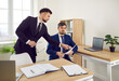 © Studio Romantic - Two male business colleagues reviewing paper documents working in modern office. Young businessman in suit pointing to document discussing business contract with lawyer. Concept of cooperation.