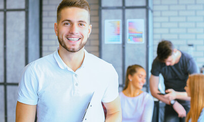 Businessman with colleagues in the background in office