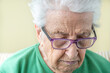© berna_namoglu - closeup portrait of an old senior woman with eye glasses