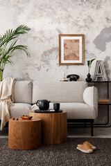 The stylish compostion at living room interior with design gray sofa, woooden coffee table, poster and elegant personal accessories. Loft and industrial interior. Template.