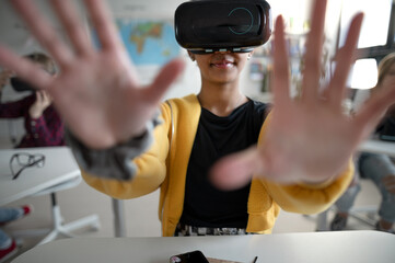 Wall Mural - close-up of student wearing virtual reality goggles at school in computer science class.