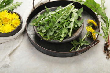 Wall Mural - Fresh dandelion on light background.