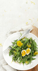 Wall Mural - Fresh dandelion salad on light background.